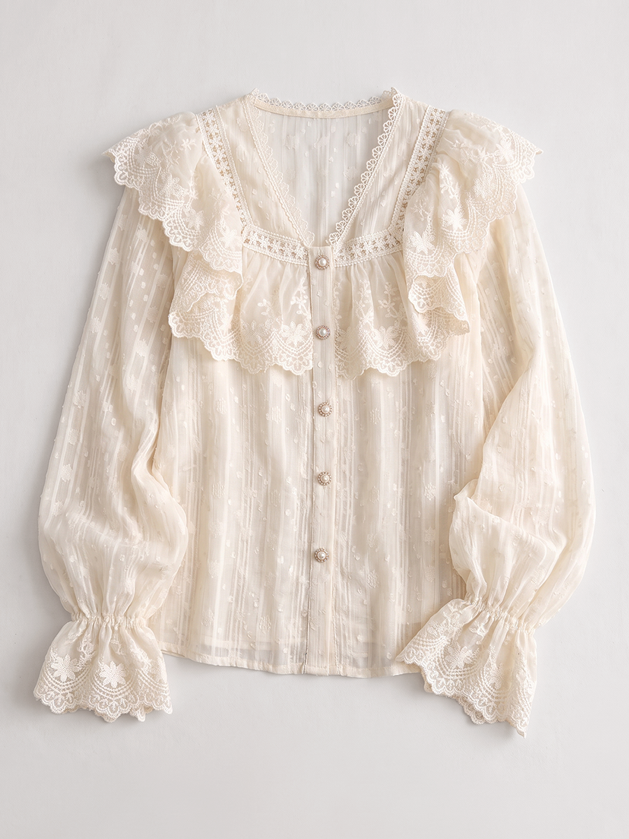 White lace blouse with a ruffled yoke shown flat without a model