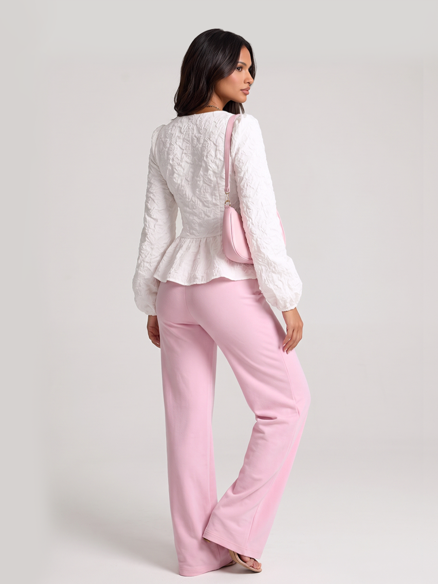 Woman wearing a white peplum blouse with a square neckline and front buttons