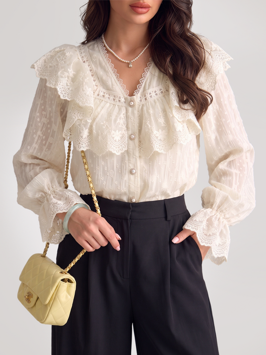 Woman wearing a white lace blouse with a ruffled yoke and long puff sleeves