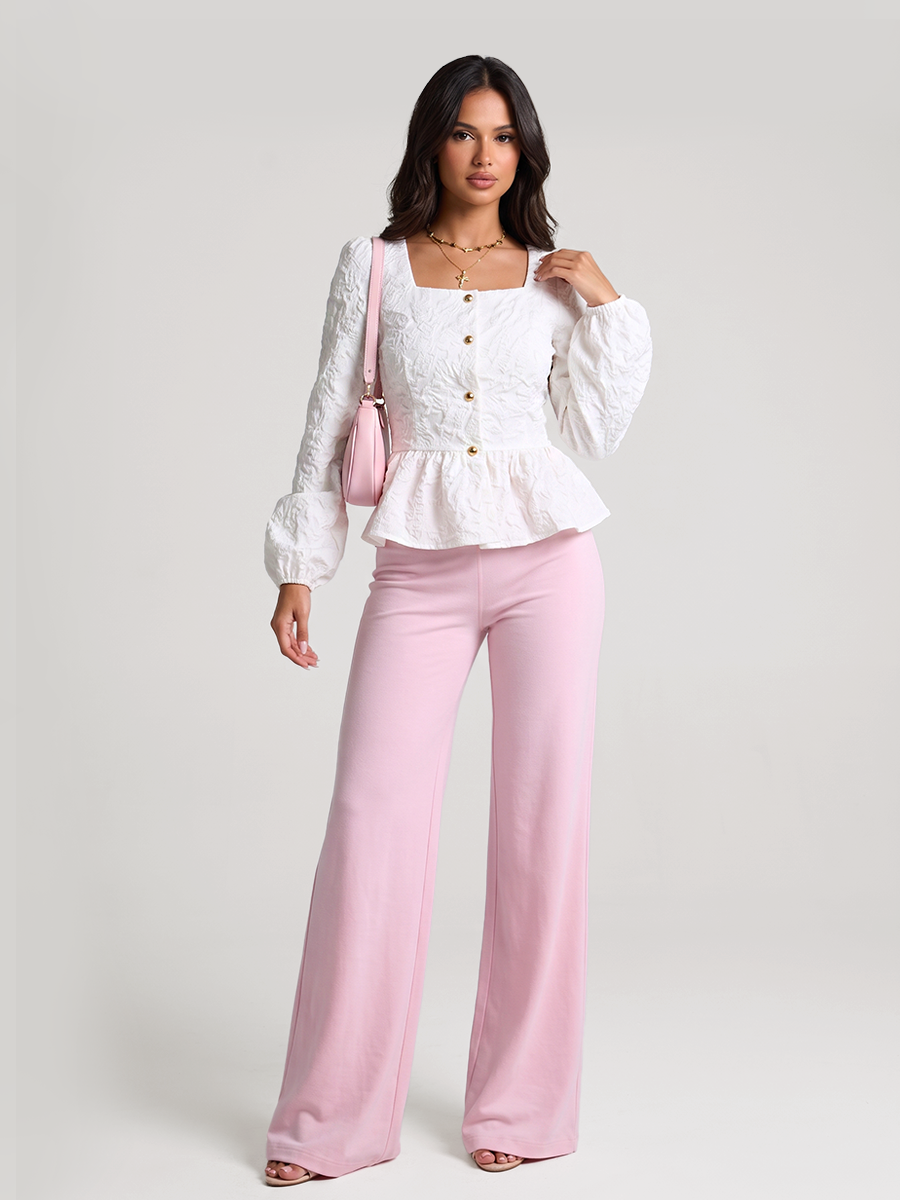 Woman wearing a white peplum blouse with a square neckline and front buttons